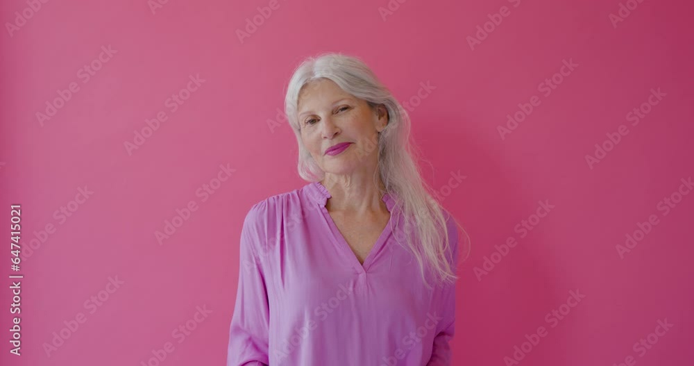 Portrait of Elegant Senior Female Looking to Camera in Pink Studio Portrait of Elegant Senior Female Looking to Camera in Pink Studio