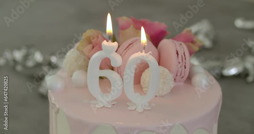 60th White Birthday Cake With Candles photo