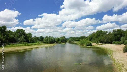 The Loire river in the middle of the green countryside in Europe, France, Burgundy, Nievre, Pouilly sur Loire, towards Nevers, in summer on a sunny day.  photo