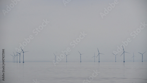 Farma turbin wiatrowych we mgle na morzu photo