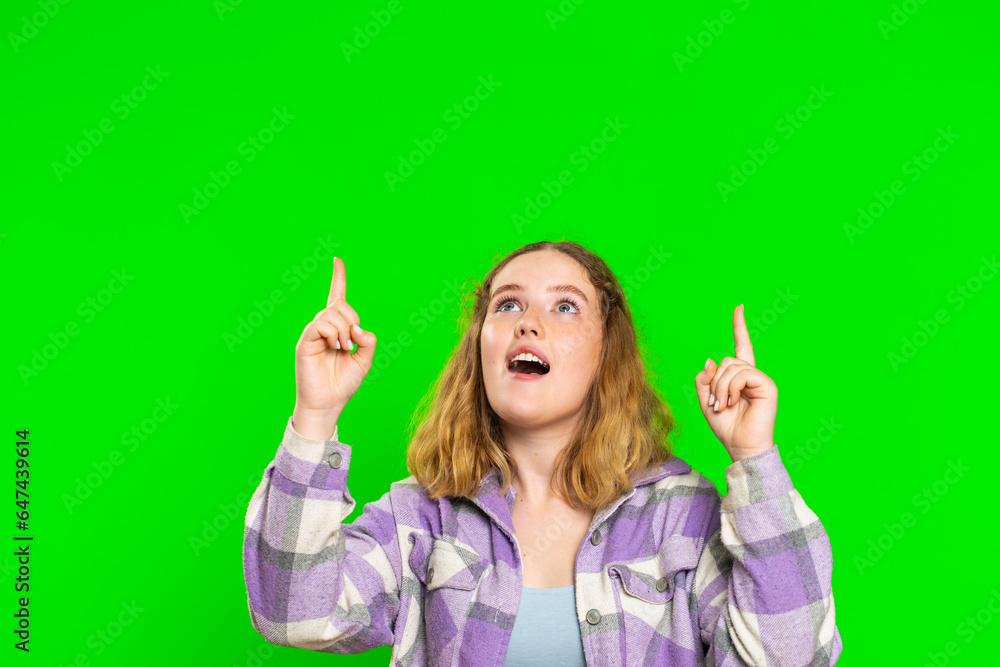 Young woman showing thumbs up and pointing empty place over head, advertising area for commercial text, copy space for goods promotion advertisement. Girl isolated on chroma key background. Lifestyles Young woman showing thumbs up and pointing empty place over head, advertising area for commercial text, copy space for goods promotion advertisement. Girl isolated on chroma key background. Lifestyles