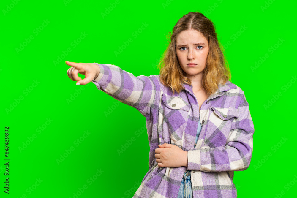 Get out of here. You are fired. Irritated caucasian woman pointing finger away asking to leave her alone, strict boss firing, conflict, quarrel. Redhead girl isolated on chroma key background indoors