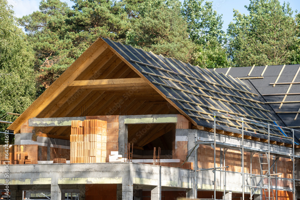 Wooden rooftop with protection waterproof layers against natural forest background