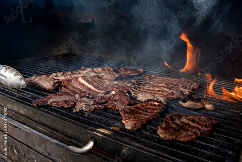 mexican style carne asada, charcoal grill for grilling arrachera and sirloin style meat, carne asada from northern mexico, carne asada tacos from sonora. photo