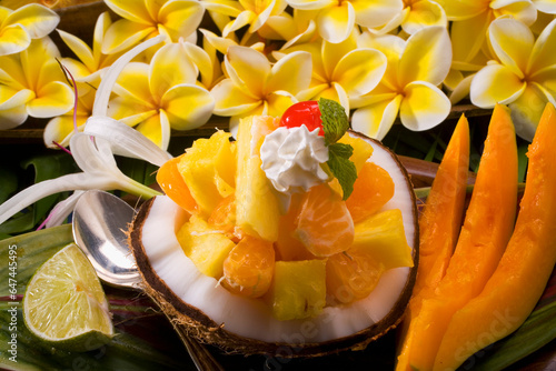Studio Shot Of A Tropical Fruit Salad With Flowers. photo