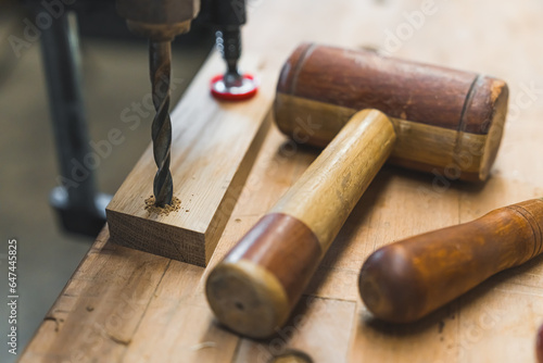 Carpenter tools, a drill and a mallet on wooden working bench. High quality photo