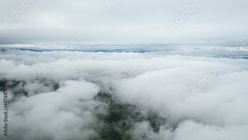 Aerial view above the white sea of clouds over the valley, natural view.