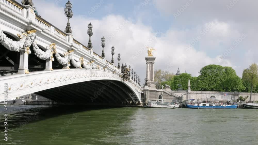 a low angle gimbal stabilized clip walking towards the pont alexandre III bridge in paris, france