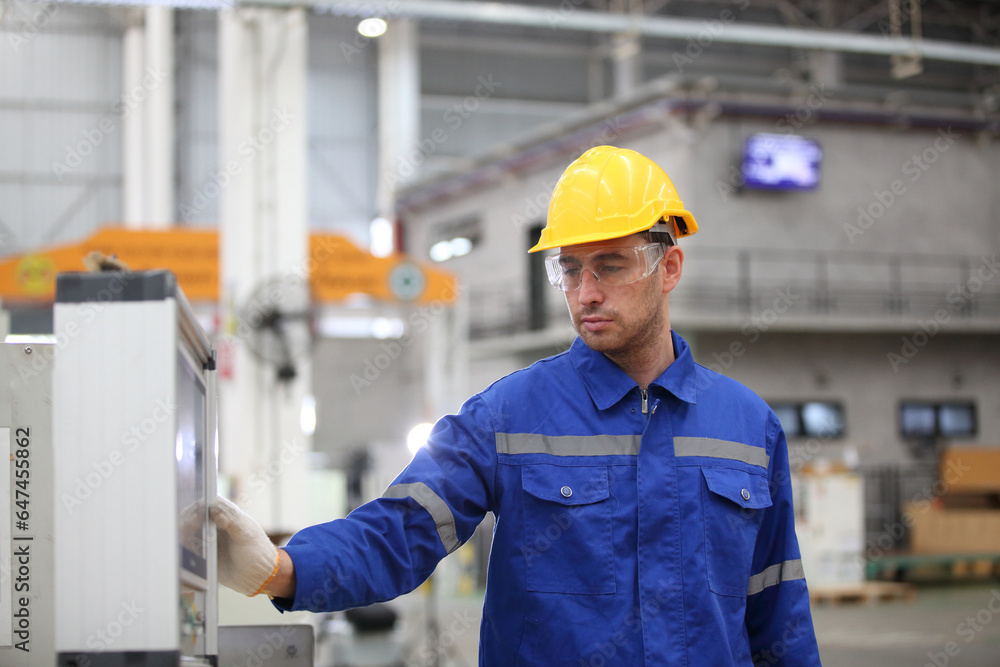 worker or engineer working in factory with safety uniform , safety hat and safety glasses , image is safety concept or happy workplace worker or engineer working in factory with safety uniform , safety hat and safety glasses , image is safety concept or happy workplace