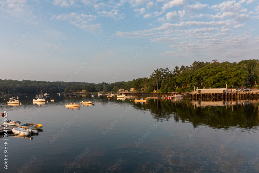Round Pond Harbor, Maine, USA, boats in the harbor on a quiet still morning at sunrise in summer