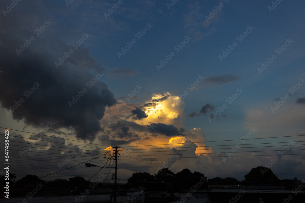 big clouds in the sky at sunset