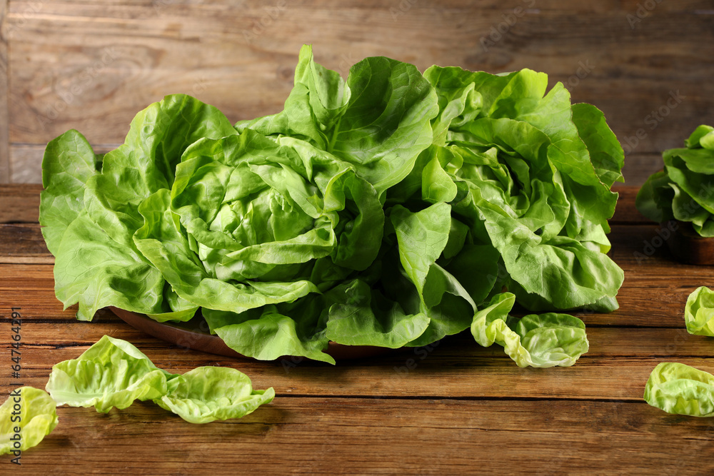 Fresh green butter lettuce on wooden table Fresh green butter lettuce on wooden table