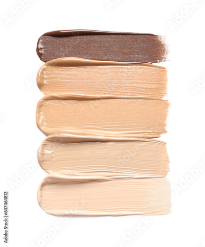 Samples of skin foundation on white background, top view