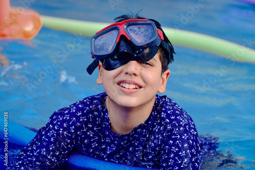 child in swimming pool,child in pool,child with snorkel and mask,person with snorkel,boy in pool, portrait of a person in a swimming goggles, portrait of a man in a swimming pool , beachwear 