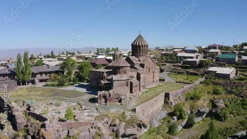 Forward reveal aerial shot of Harichavank Monastery on sunny summer day. Harich village, Shirak Province, Armenia. photo