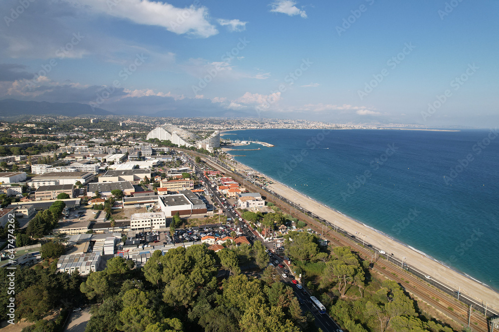Fototapeta premium Aerial photography. Top view of the trees of Vaugrenier Park, the city of Villeneuve-Loubet-Plage France and the Mediterranean Sea.