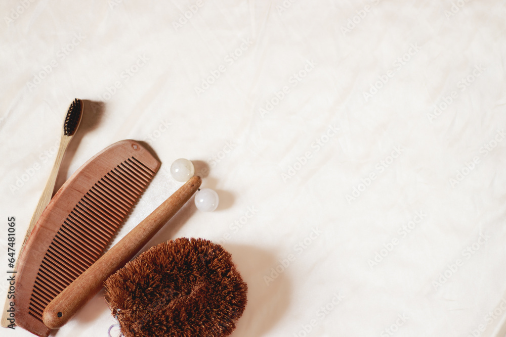 Overhead view of wooden comb, body brush, bamboo toothbrush and facial ...