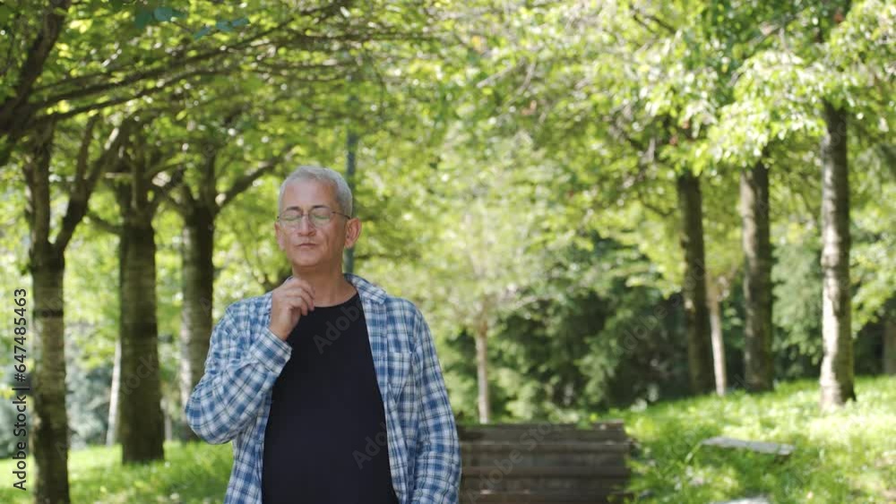 Thoughtful man walking outdoors.
