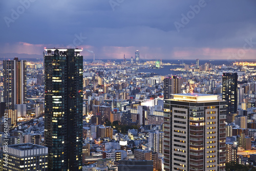 Storm Clouds Over A City Illuminated With Lights; Osaka, Japan photo