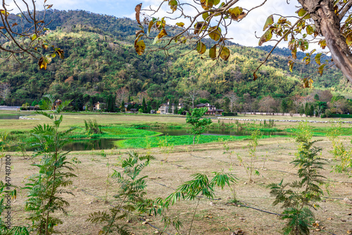 The natural background of colorful flower beds, with chairs to sit and rest while watching the scenery, the wind blows through the blur, cool and comfortable. photo