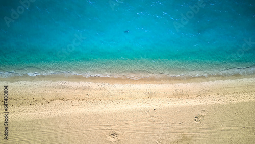 Aerial above photo of sandy beach and ocean with waves