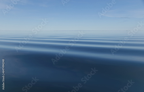 Surface Of Blue Water With Slight Ripples And Blue Sky With Horizon In The Distance photo