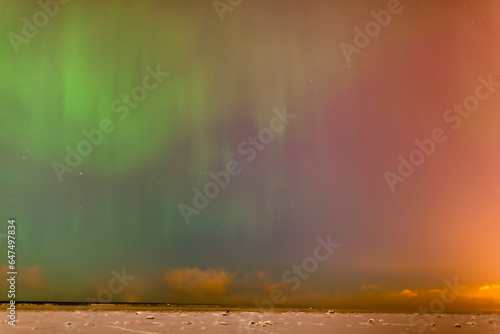 The northern lights dance in the night sky above knik arm in this view from the tony knowles coastal trail in winter; Anchorage alaska united states of america photo