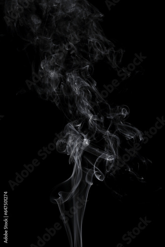 Fototapeta Naklejka Na Ścianę i Meble -  Abstract white smoke swirls on black background.