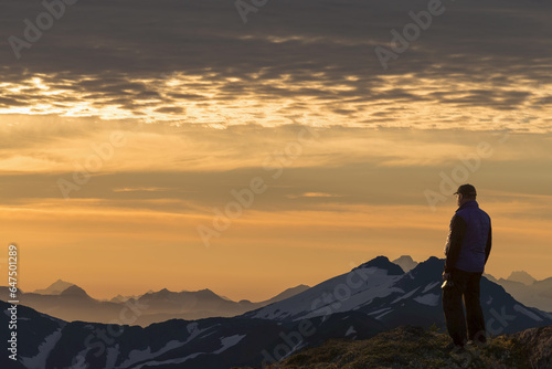 View Of Coast Mountains And Hiker At Sunrise In The Alpine On Douglas Island In Alaska's Tongass National Forest, Juneau. Alaska photo