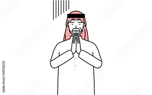 体の前で手を合わせて謝るイスラムのシニア男性