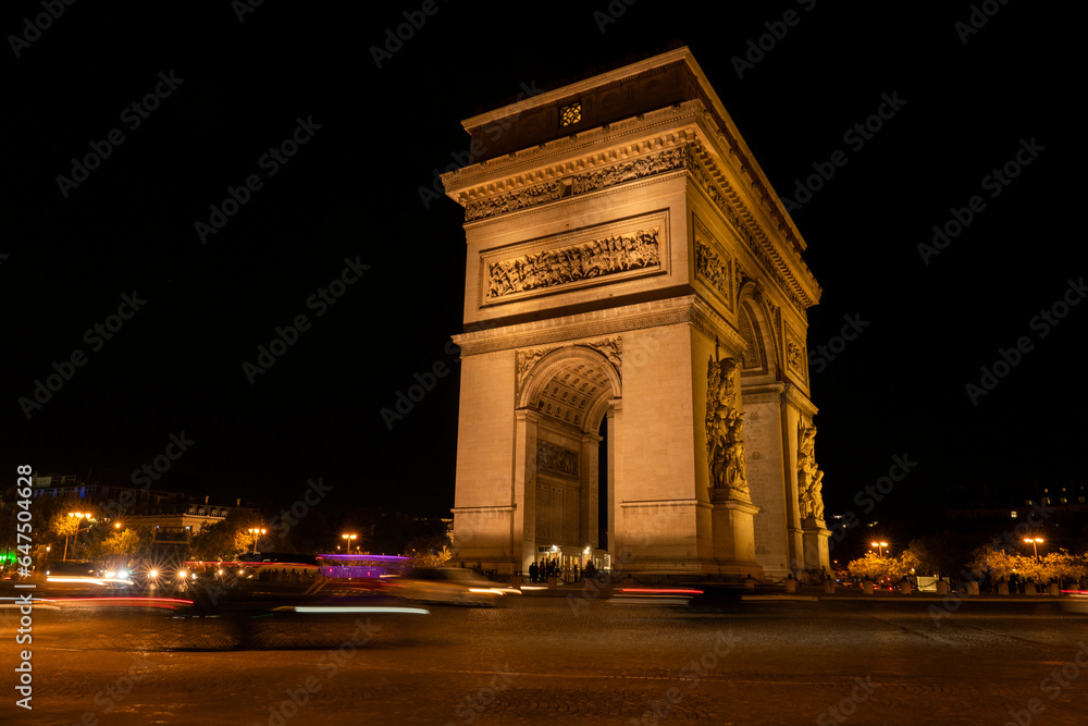 Iconic Arc de Triomphe illuminated at night in Paris; Paris, France Iconic Arc de Triomphe illuminated at night in Paris; Paris, France