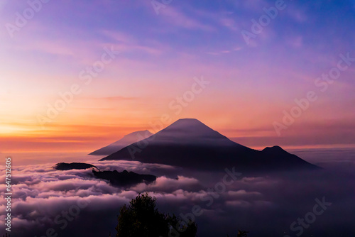 The beautiful view of the sunrise with Mount Sindoro, Mount Sumbing, and Mount Kembang as well as the sea of ​​clouds between the two is a truly amazing sight. photo