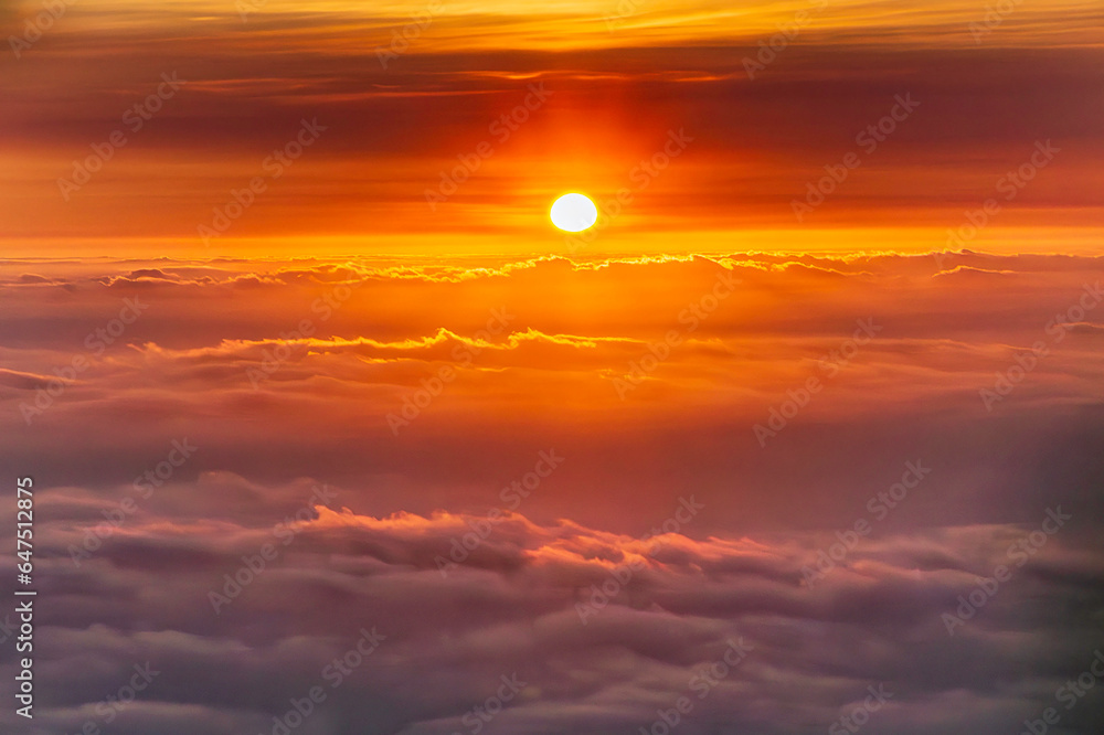 The beautiful view of the sun rising above the sea of clouds is so exotic and full of magic The beautiful view of the sun rising above the sea of clouds is so exotic and full of magic