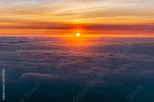 The beautiful view of the sun rising above the sea of ​​clouds is so exotic and full of magic