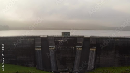 Cinematic aerial view of the Spelga Dam. Northern Ireland. Misty sky photo