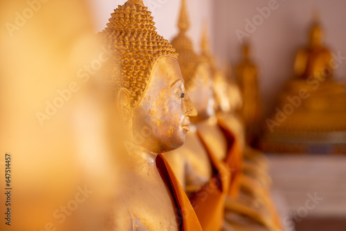 multiple Buddha statues in the temple. © wachayan