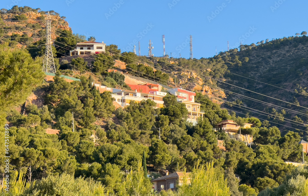 Houses on Mountain, view. Mountains landscape. Towhouse and Home on hills. House in mountains. Villa in mountains in El Picaio, Valencia, Spain. Rural landscape with hills.