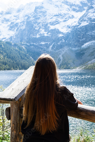 Young woman enjoying nature in Morskie Oko Snowy Mountain Hut in Polish Tatry mountains Zakopane Poland. Naturecore aesthetic beautiful green hills. Mental and physical wellbeing Travel outdoors © anna.stasiia