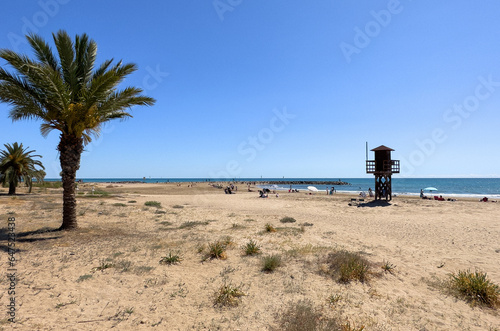 Lifeguard tower on sea beach. Miami Beach with lifeguard tower. Rescue tower with lifeguard to watch swimmers in sea to prevent drowning and danger. Spain beach with rescue tower in Mediterranean