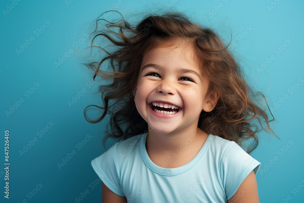 Studio portrait of cuttle little laughing girl on different colours background Studio portrait of cuttle little laughing girl on different colours background