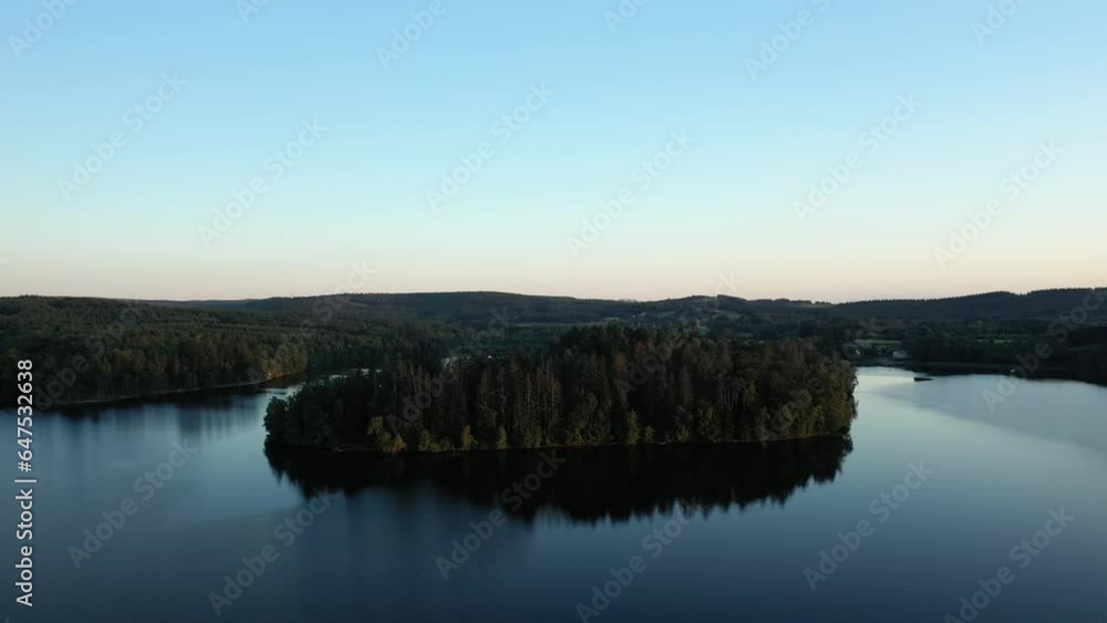 The Settons lake surrounded by its green nature in Europe, in France, in Burgundy, in Nievre, towards Chateau Chinon, in summer, on a sunny day. The Settons lake surrounded by its green nature in Europe, in France, in Burgundy, in Nievre, towards Chateau Chinon, in summer, on a sunny day.