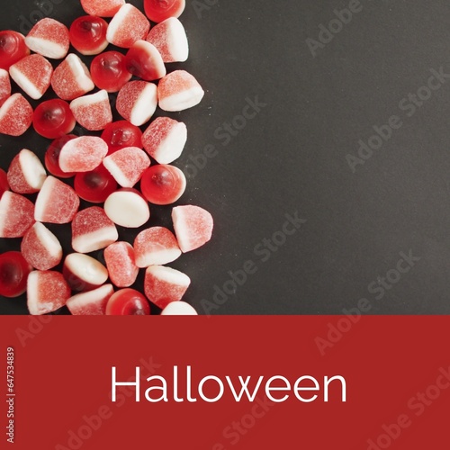 Halloween text on red with trick or treat sweets on black with copy space