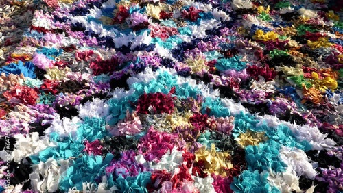 Colorful handmade, traditional, Moroccan carpet, rug, made with fabric and cloth waste material. Concept of upcycling useless material. Abstract pattern background 4k footage.