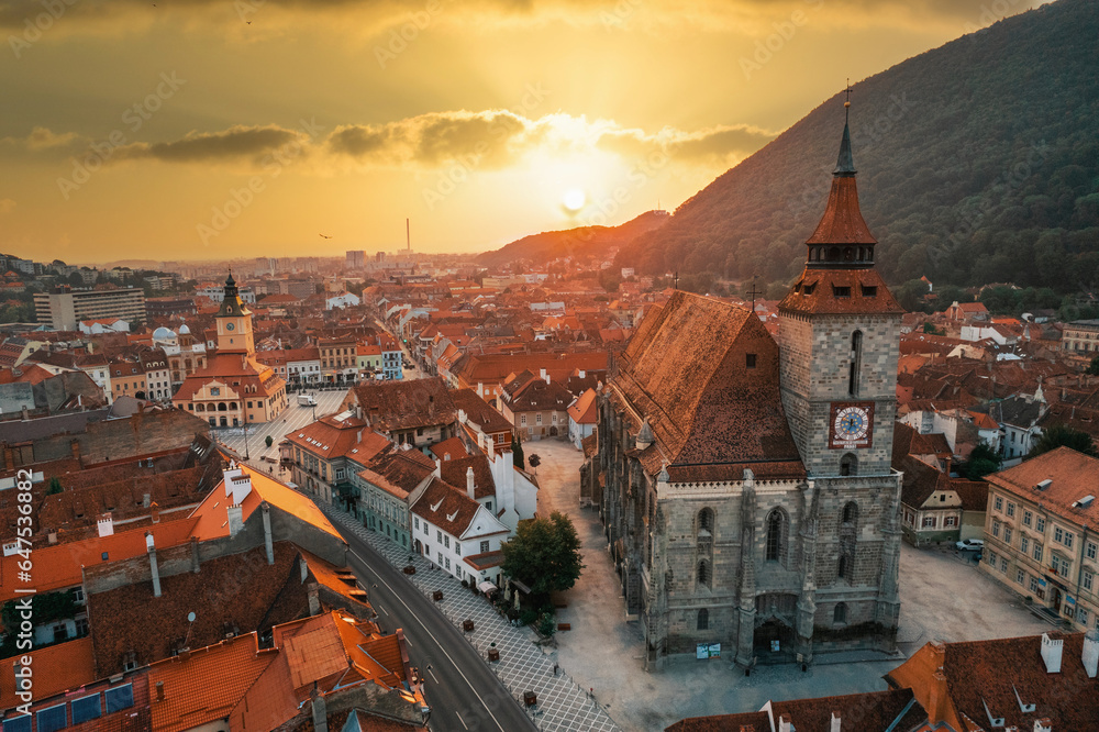 Aerial drone view of the The Black Church in Brasov at sunset, Romania - obrazy, fototapety, plakaty 