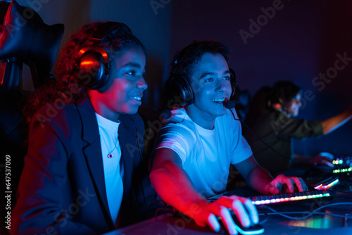 Teens playing in video game club