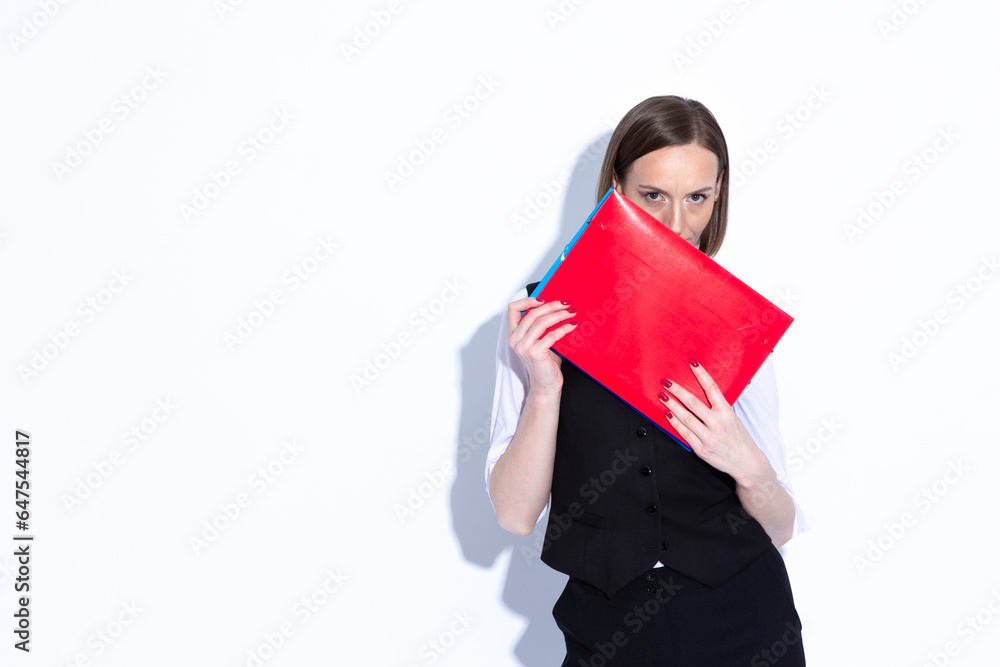 Portrait of Winsome Positive Confident Caucasian Business Woman in Black Suit Demonstrating Red Folder Over White Portrait of Winsome Positive Confident Caucasian Business Woman in Black Suit Demonstrating Red Folder Over White