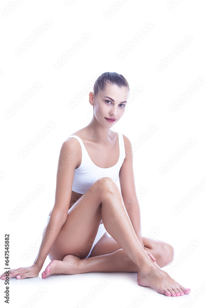 Spa Ideas. Nude Winsome Caucasian Female With Tanned Curved Slim Body Sitting With Crossed Legs In White Lingerie Posing Over White