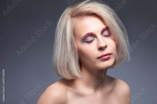 Beauty Concept. Portrait of Winsome Beautiful Caucasian Blond Woman Against Gray.