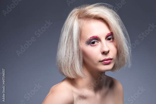 Beauty Concept. Portrait of Winsome Beautiful Caucasian Blond Woman Against Gray