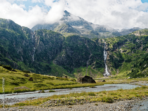 Sulzenaufall waterfall in the Stubai Alps in Austria. A green valley, rocky mountains and a powerful waterfall photo